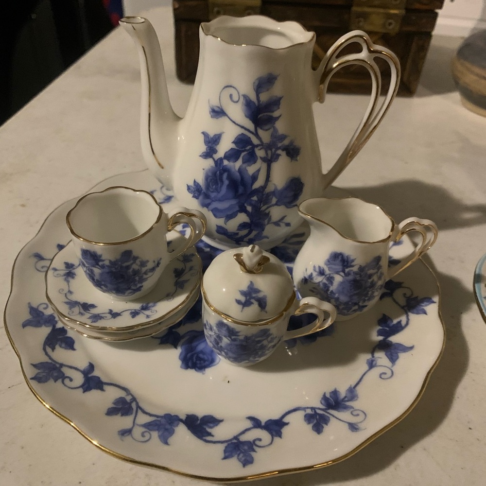vintage  mini porcelain tea set featuring a blue rose floral pattern with gold t